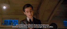 a man in a suit and tie is talking about an entire square block