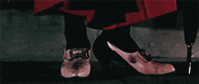 a woman in a red skirt is wearing pink shoes
