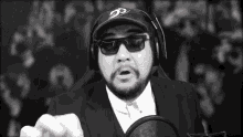 a man with a beard wearing sunglasses and a hat with the letter d on it