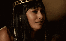 a close up of a woman 's face with a tiara on her head
