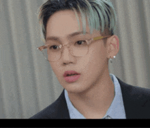 a close up of a person wearing glasses and earrings with the word baby above them