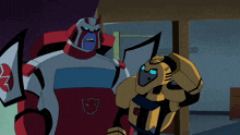 two transformers are standing next to each other and one of them has a red and white shirt on