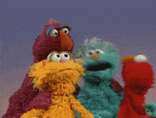 several sesame street characters are posing for a picture together