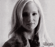 a black and white photo of a woman 's face with the words `` you suck '' .