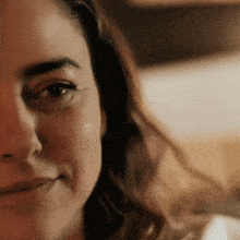 a close up of a woman 's face with a smile