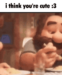 a man with a beard is sitting at a table eating food and says i think you 're cute