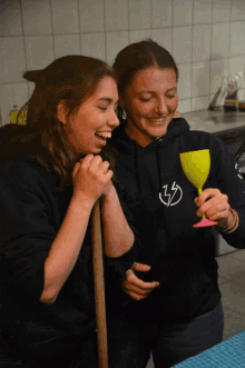 a woman wearing a black sweatshirt with a lightning bolt on it
