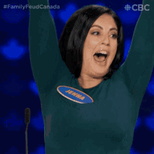 a woman with her arms in the air is wearing a jemma shirt