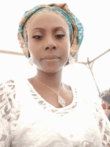 a woman wearing a head scarf and a necklace
