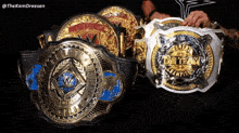 a man is holding a wrestling belt that says the kamdreesen