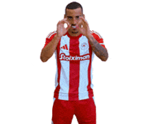 a soccer player wearing a red and white jersey with the word stoiximan on the front