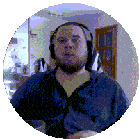 a man wearing headphones and a blue jacket looks at the camera