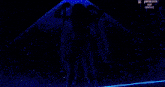 a woman in a white and gold costume is standing in the rain on a stage .