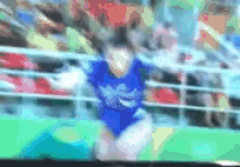 a blurry picture of a person wearing a blue shirt with the word eagle on it