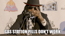 a man sitting at a table with gas station pills do n't work written on the bottom