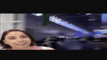 a blurry picture of a woman in a pink shirt