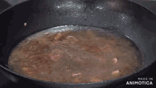 a man is cooking in a kitchen with a bag of good life egg noodles in the background