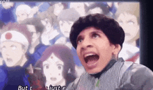 a man is making a funny face in front of a group of people .