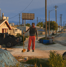 a man standing on a street with a broom in his hand