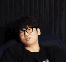 a man wearing glasses and a shirt that says " visible " on it