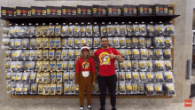 a man wearing a red shirt that says zippdogs stands next to a boy in a reindeer outfit