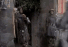 a blurry picture of two people standing next to each other in a dark room .