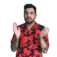 a man with a beard wearing a red and black shirt is clapping his hands