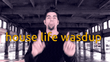 a man giving a thumbs up in front of a sign that says " house life wasdup "