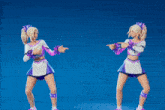 two cheerleaders are dancing in front of a blue backdrop