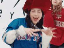 a woman wearing a blue new york jersey