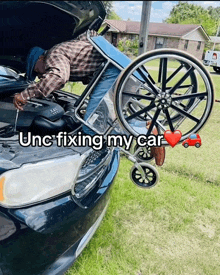 a man in a wheelchair is working on a car with the hood open