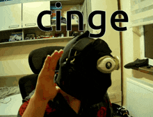 a person wearing a black mask with the word cinge above it