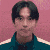 a pixelated image of a young man 's face with a pink background