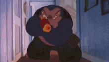 a cartoon character is standing in a hallway holding a red object in his mouth .
