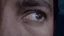 a close up of a man 's eye with a reflection