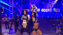 a couple of women standing next to each other on a stage
