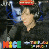 a man wearing headphones is smiling in front of a sign that says nice so much