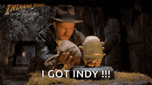 a movie poster for indiana jones and the last crusade shows a man holding a golden ball