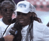 a woman wearing a white hat that says champions on it