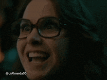 a close up of a woman wearing glasses with the username lialmeida05