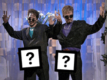 two men standing next to each other with a question mark on their frames