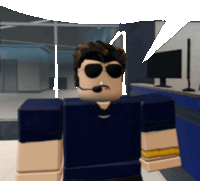 a man wearing sunglasses and a headset stands in front of a computer