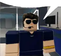 a man wearing sunglasses and a headset stands in front of a computer