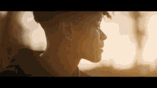 a close up of a person 's face with the sun shining on it