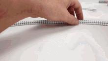 a person is playing with a tower made of magnets and beads