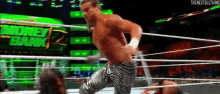 a man in a wrestling ring with a sign that says money bank