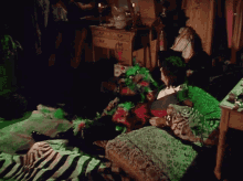 a woman sits on a couch in a room covered in green