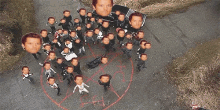 a group of men are standing around a pentagram with their faces drawn on it