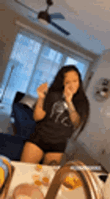 a woman is taking a picture of herself in front of a mirror in a living room .
