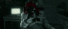 a clown with red hair is sitting in front of a computer screen .